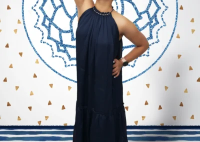 A portrait of a young Indian woman posing in a composited scene